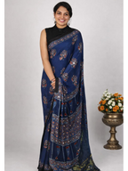 MIZHI Ajrakh modal silk saree with intricate mirror work, showcasing vibrant traditional patterns and elegant craftsmanship.