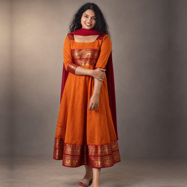 Sunset orange Kanji cotton Anarkali dress by MIZHI featuring traditional embroidery and flowing silhouette.