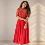 Elegant red embroidered panelled georgette Anarkali dress with handwork details by MIZHI, featuring intricate embroidery and a flowing silhouette.