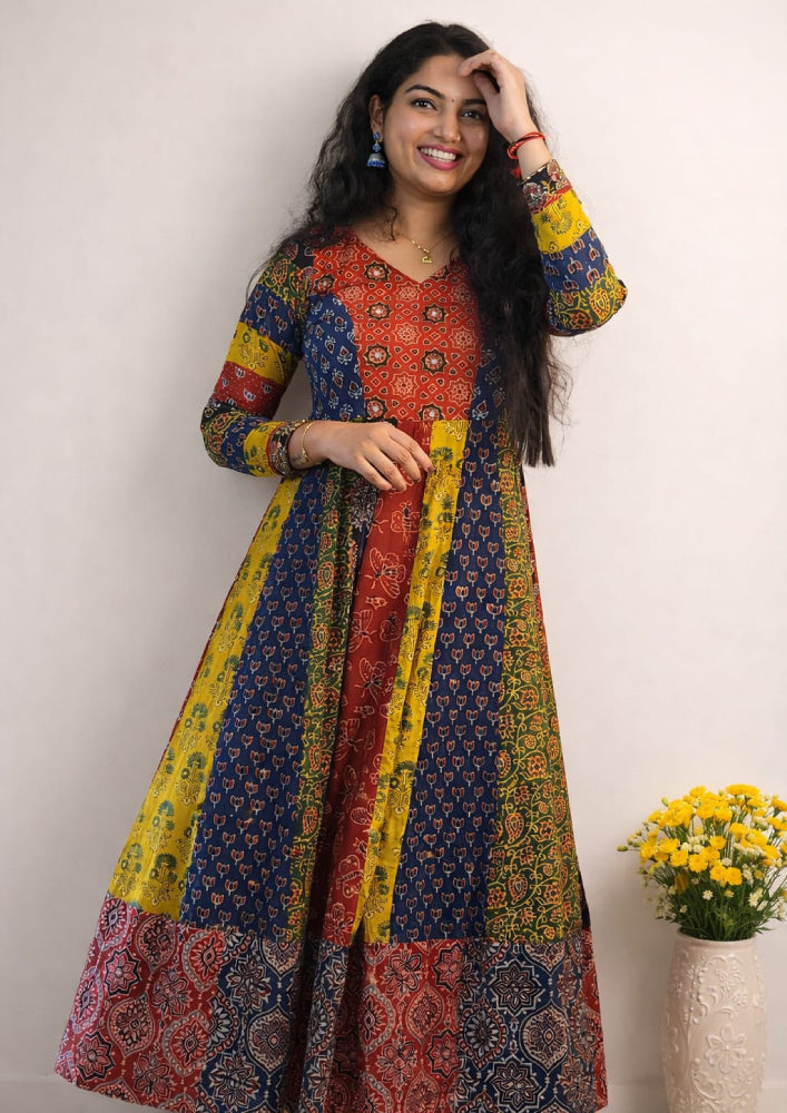 MIZHI Ajrakh multi-paneled Anarkali dress with intricate traditional print and flowing fabric, displayed on a mannequin.