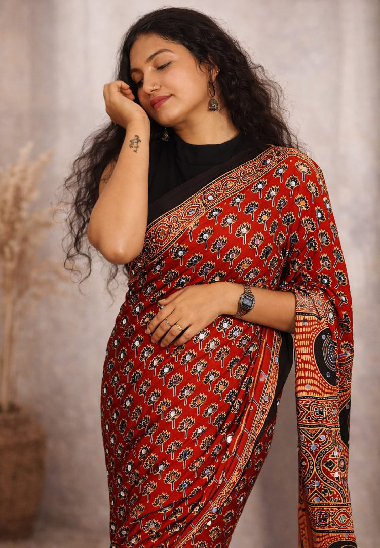 Beautiful Mirror Work Ajrakh Saree by MIZHI featuring traditional ajrak fabric with intricate mirror embellishments.