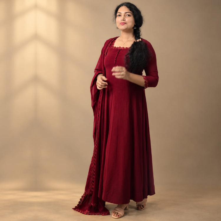 Brown paneled Georgette Anarkali dress by MIZHI featuring intricate embroidery and flowing fabric.