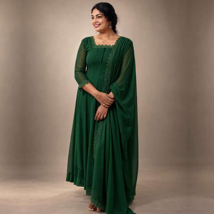 Green paneled Georgette Anarkali dress by MIZHI with intricate embroidery and flowing silhouette.