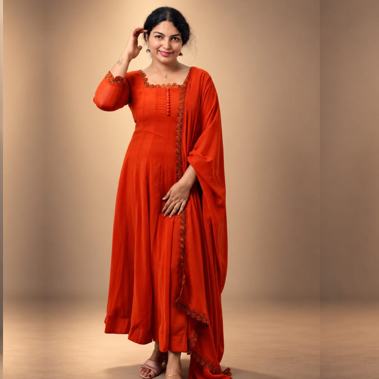 Orange paneled Anarkali dress in georgette fabric by MIZHI, featuring elegant paneling and intricate design details.
