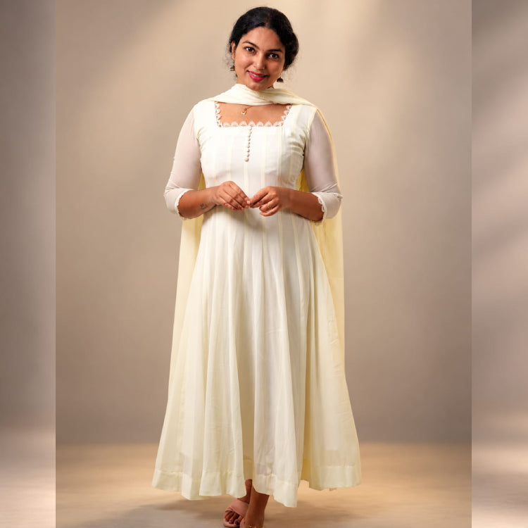 White MIZHI paneled Anarkali dress in georgette fabric featuring intricate panel designs and elegant flowy silhouette.