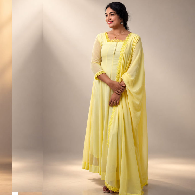 Pastel lemon yellow paneled Anarkali dress by MIZHI in flowing georgette fabric, featuring intricate panel details.