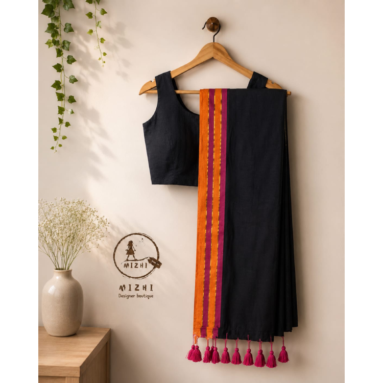 Black Mul cotton saree with colorful border by MIZHI, showing the draped fabric and intricate border details.