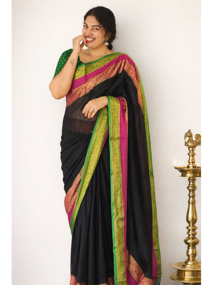Black MIZHI mul cotton saree draped elegantly, showcasing its soft texture and traditional design.