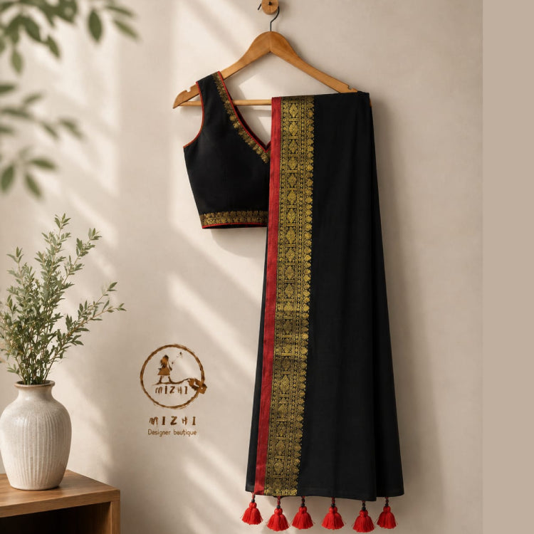 Black Mul Cotton Saree by MIZHI with elegant golden accents and intricate design, showcasing traditional Indian textile craftsmanship.