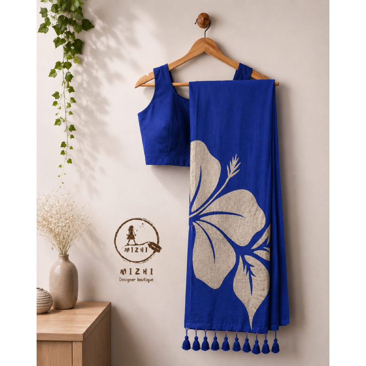Royal blue Hibiscus mul cotton saree by MIZHI featuring intricate floral patterns and traditional design.