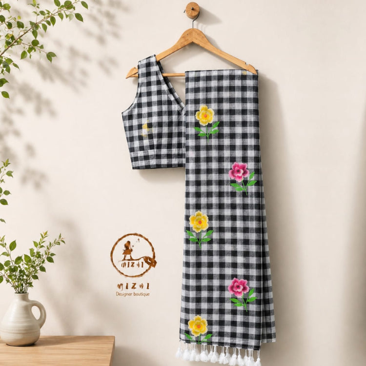 Black and white Madras check handpainted Mul cotton saree by MIZHI, featuring traditional checked pattern and lightweight fabric.