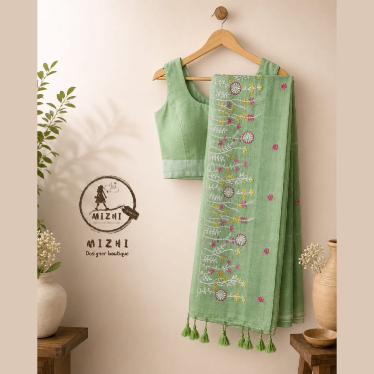Green MIZHI embroidered mul cotton saree with intricate embroidery and lightweight fabric, perfect for traditional and casual wear.
