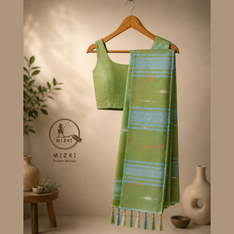 Green Cotton Jamdani saree by MIZHI featuring intricate traditional patterns and a flowing, elegant fabric.