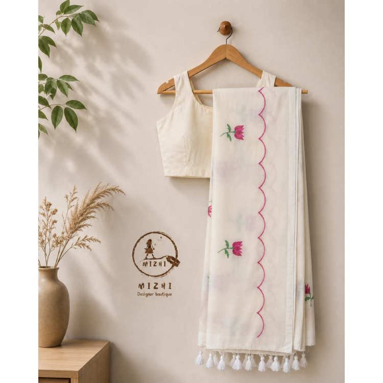 Ivory white floral scallop mul cotton saree by MIZHI with intricate floral patterns and scalloped border, draped elegantly.