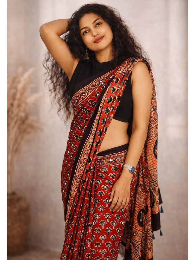 Mirror work Ajrakh saree by MIZHI featuring intricate mirror embroidery and traditional Ajrakh block print fabric.