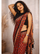 Mirror work Ajrakh saree by MIZHI featuring intricate mirror embroidery and traditional Ajrakh block print fabric.