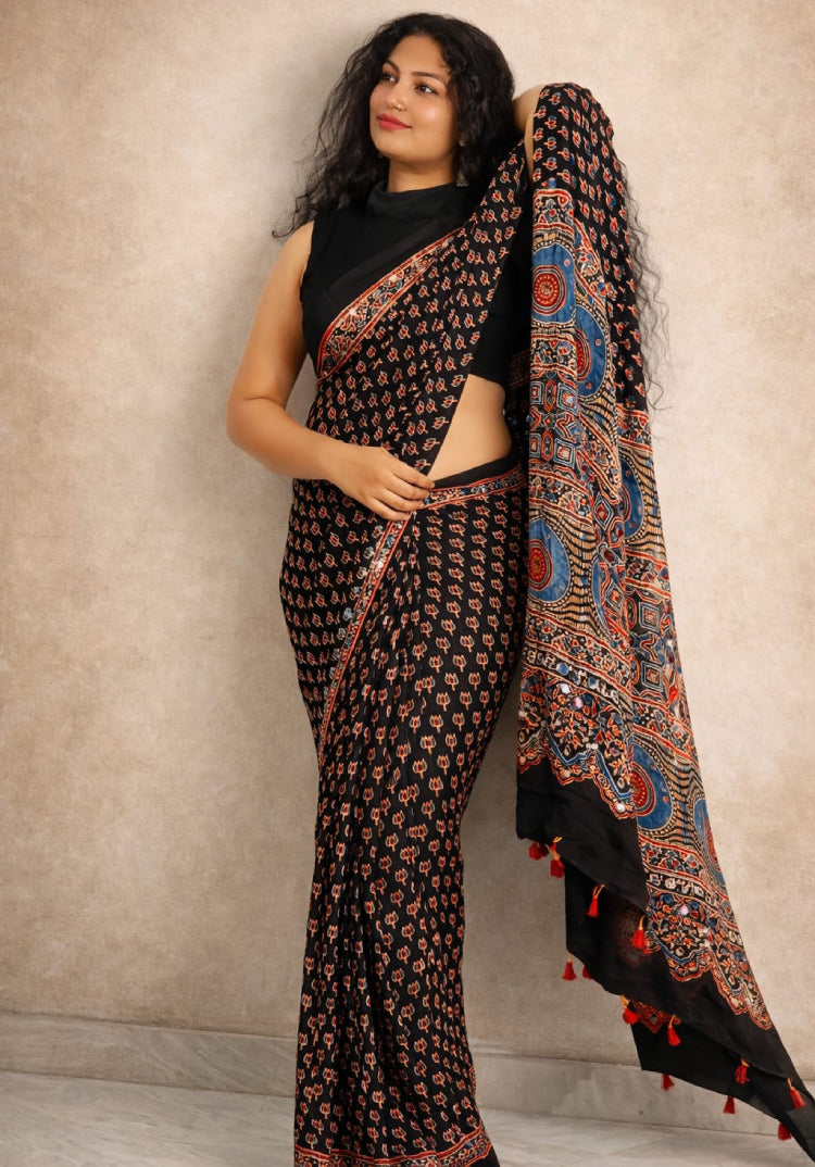 MIZHI Mirror Work Ajrakh Saree featuring intricate mirror embroidery and traditional Ajrakh print in earthy tones.