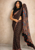 MIZHI Mirror Work Ajrakh Saree featuring intricate mirror embroidery and traditional Ajrakh print in earthy tones.