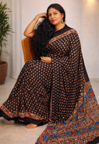 Mirror Work Ajrakh Saree by MIZHI featuring traditional ajrak fabric with intricate mirror embroidery and vibrant patterns.