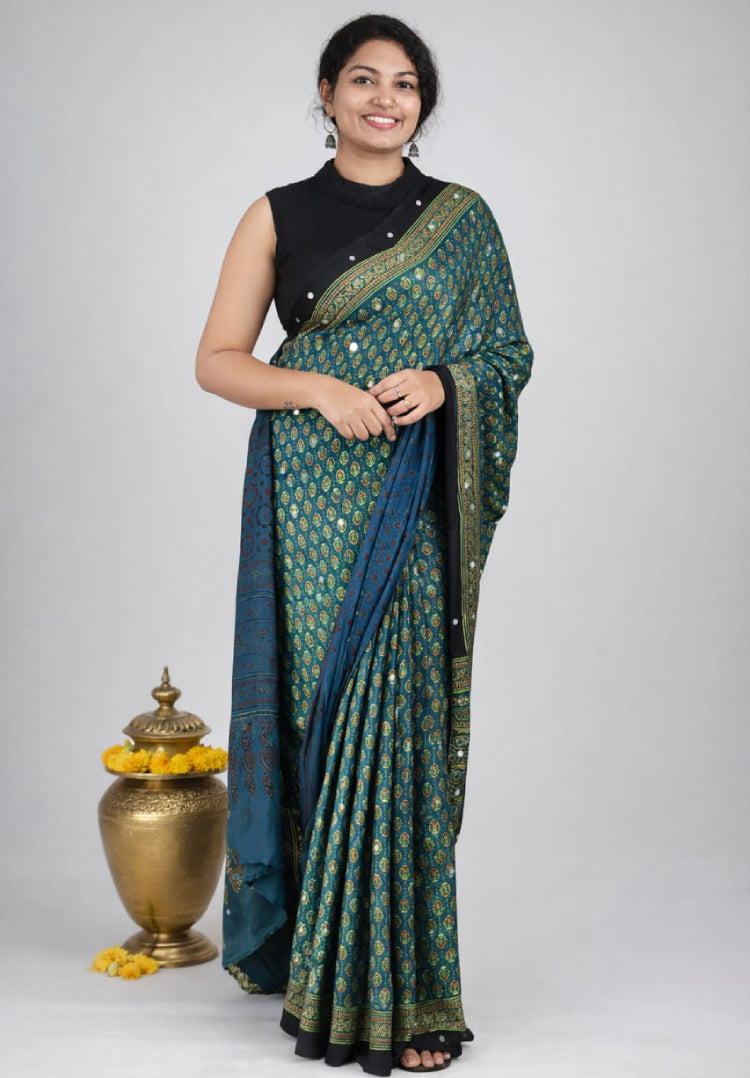 Elegant modal silk saree by MIZHI featuring smooth fabric and intricate design, draped to showcase its luxurious texture and vibrant color.