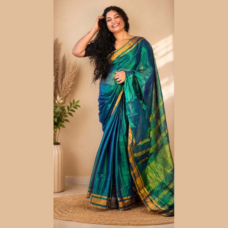 MIZHI Mul Tissue Saree in elegant multicolor fabric with intricate traditional design, draped beautifully for festive occasions.