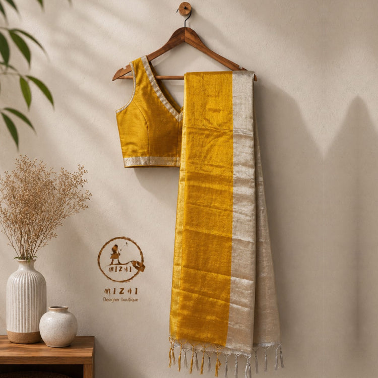 MIZHI Mul Tissue Cotton Saree with Gold Stripes, elegant traditional Indian attire in soft, luxurious fabric with intricate design.