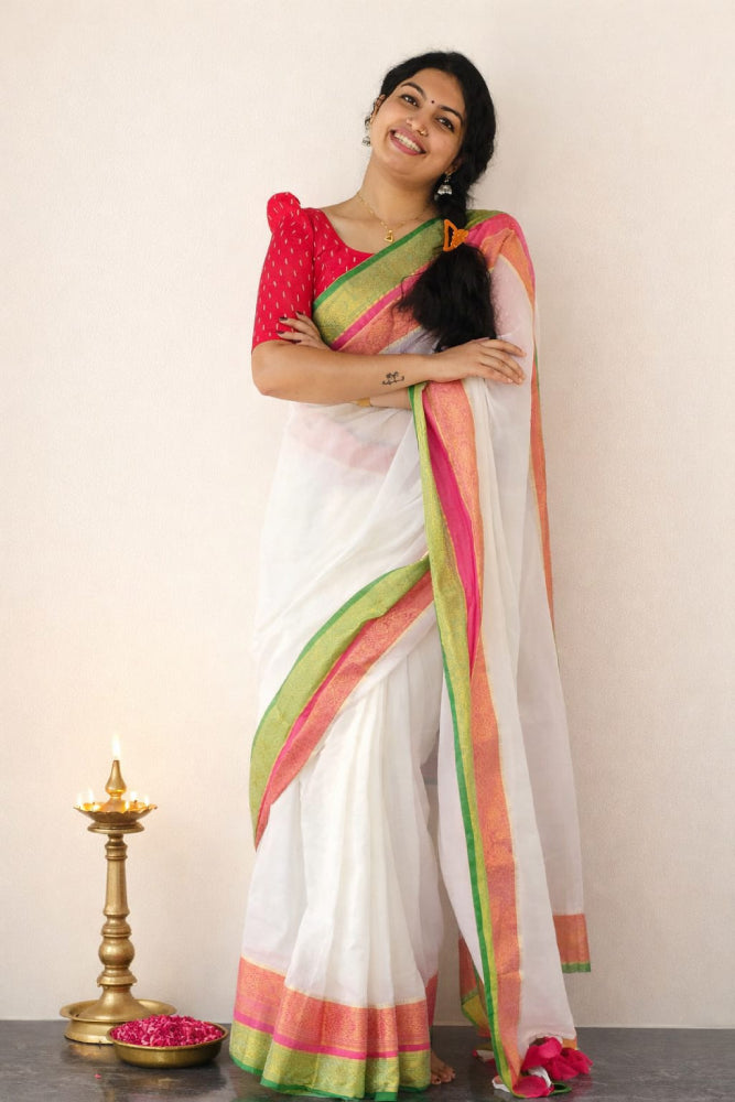 MIZHI mul cotton saree featuring a vibrant pink border, draped elegantly on a model.