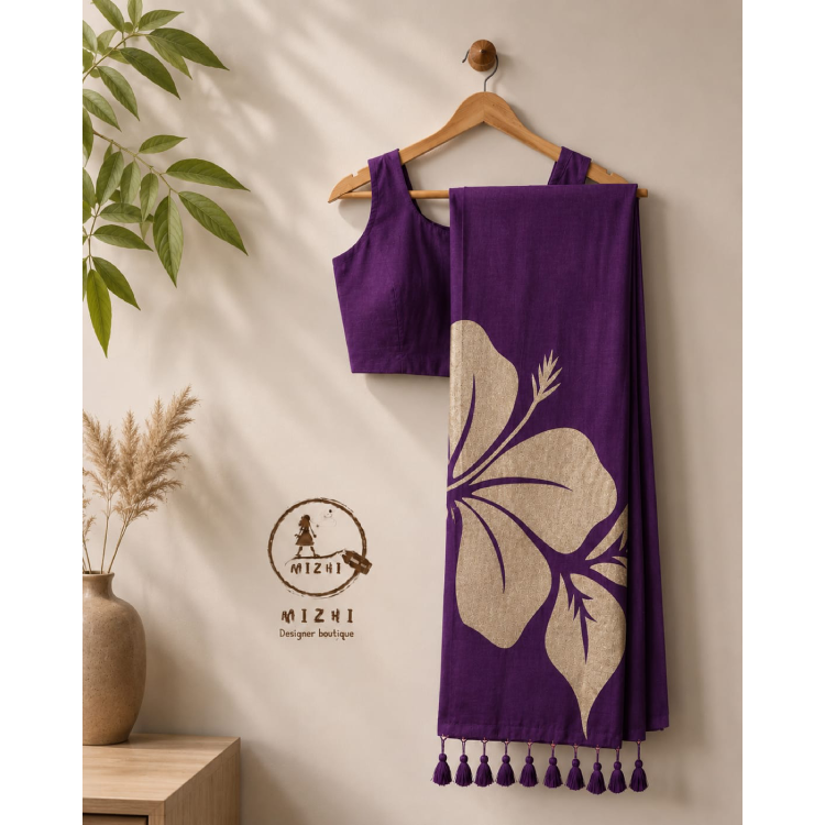 Deep purple handcrafted hibiscus Mul cotton saree by MIZHI featuring intricate floral designs and traditional draping style.