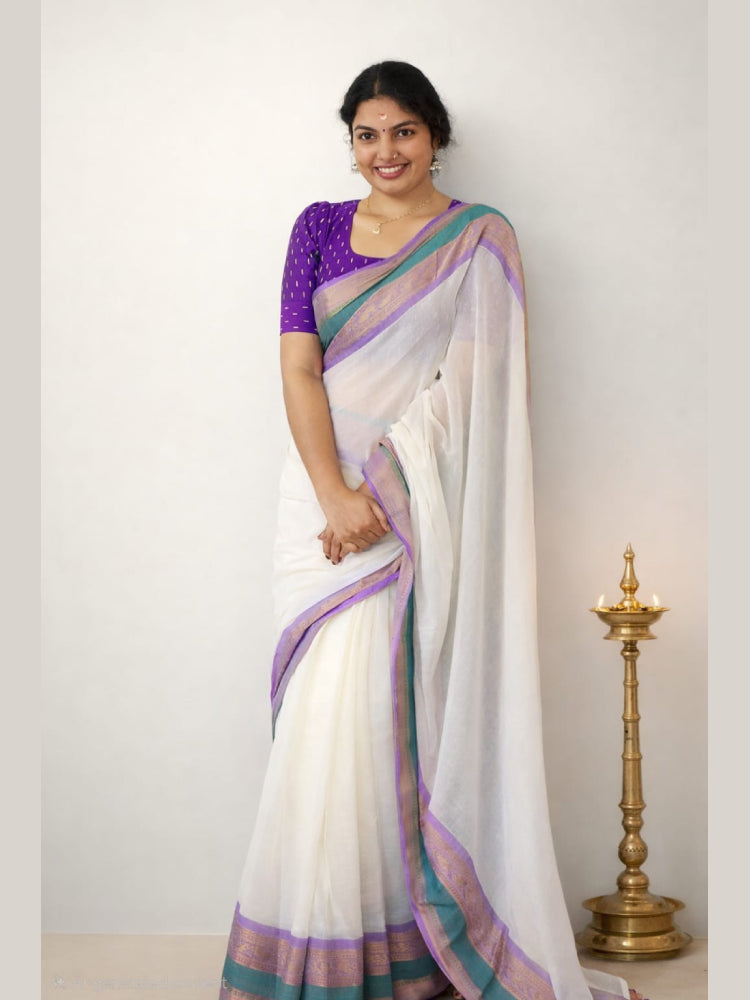 Purple border MIZHI mul cotton saree draped elegantly, showcasing its soft texture and vibrant color combination.