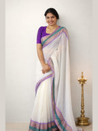 Purple border MIZHI mul cotton saree draped elegantly, showcasing its soft texture and vibrant color combination.